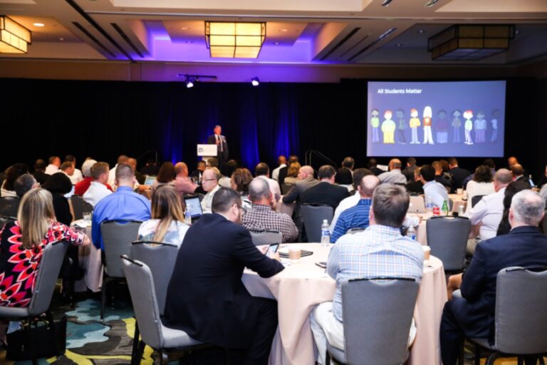 Attendees watch a presentation at the Technology Leadership Summit